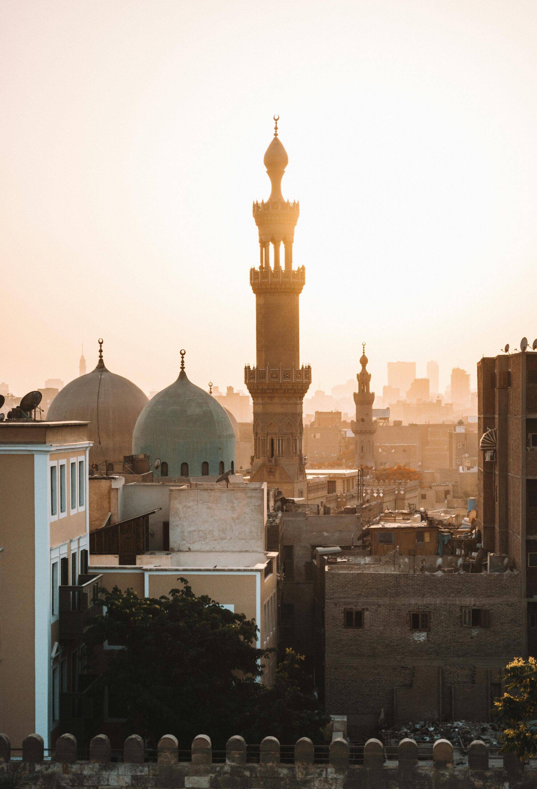 A stunning view of mosque minarets at sunset in Cairo, highlighting cultural architecture.